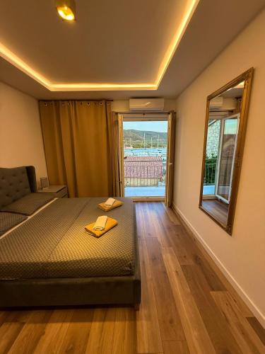 a bedroom with a bed and a large window at Villa Lungomare-Large Waterfront Apartment -Lungomare Promenade 6 in Cres