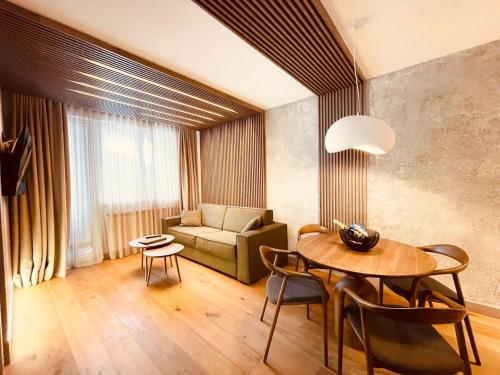 a living room with a table and a couch at Apartman 206 in Jahorina