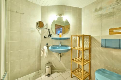 a bathroom with a sink and a mirror at Alpenhof Wallgau in Wallgau
