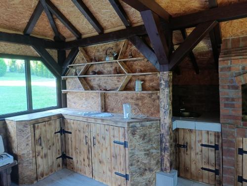 a kitchen in a barn with wooden cabinets at Hil in Rakovica