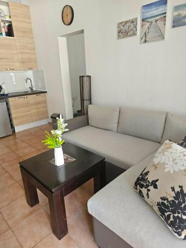 a living room with a couch and a coffee table at Apartament Sorrento Paradise in Marina Cape in Aheloy