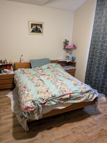a bedroom with a bed with a blanket on it at Masonville Guesthouse in London