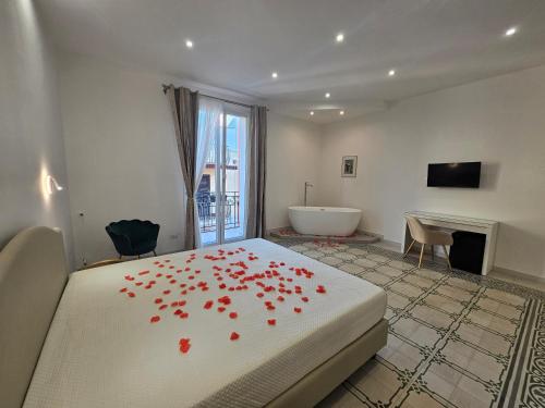 a bedroom with a bed with red rose petals on it at Palazzo Sorge - Sicilian Charm in Balestrate