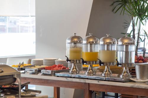 a buffet with two glasses of orange juice and fruit at Hotel Guarani Asuncion in Asuncion