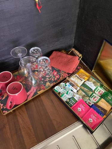 a tray with glasses and other items on a counter at The Shangri La Sunset Yurt in Tenbury