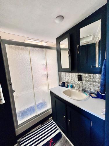 a bathroom with a sink and a mirror at Hidden Anchor in Burton