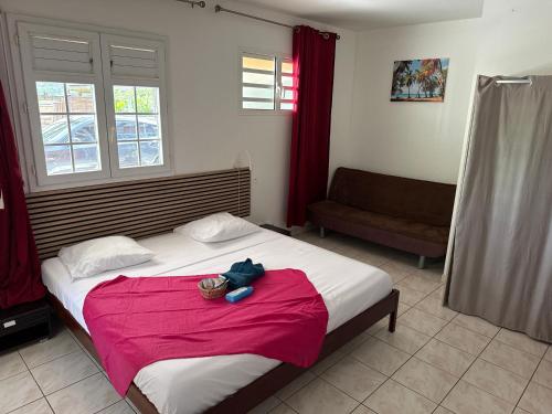 a bedroom with a bed with a stuffed animal on it at Kaz Gwayav Dous in Gros-Morne