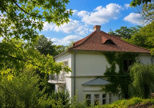 a white house with a red roof at HAUS 1926 Łagów Boutique Villa in Łagów