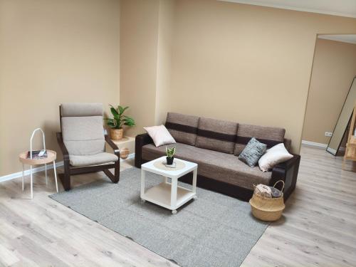 a living room with a couch and a chair at Lerihouse in Saulkrasti