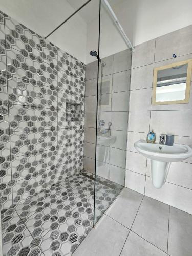 a bathroom with a shower and a sink at Troi beach house in Vlorë