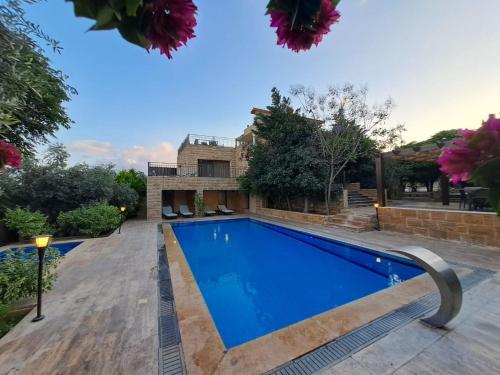 a swimming pool in the backyard of a house at Villa Saya Jerash in Jerash