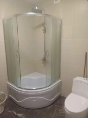 a glass shower in a bathroom with a toilet at Apartment Entier apartment in Chakvi