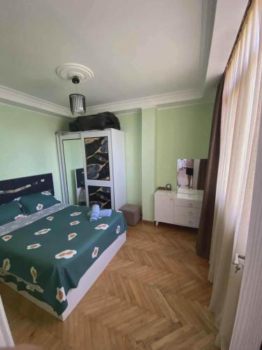 a bedroom with a bed and a dresser with a mirror at Apartment Entier apartment in Chakvi