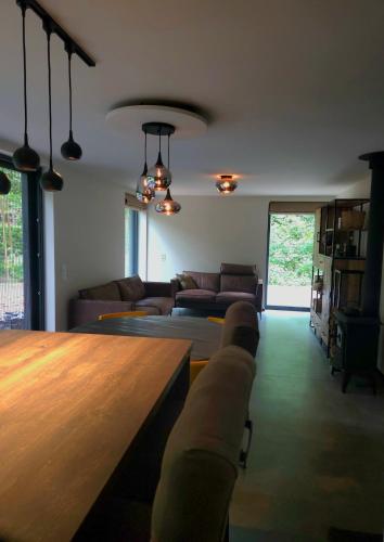 a living room with a couch and a table at Whispering Pines in Retie