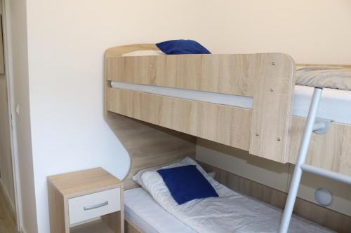 a bunk bed with blue pillows on it at Bjelašnica Escape in Bjelašnica