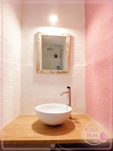 a bathroom with a white bowl sink on a wooden counter at Casa Rose, Petit cocon avec jardin dans un quartier calme de Toulon in Toulon