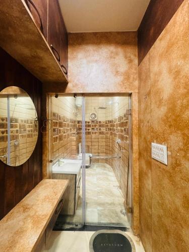 a bathroom with a shower and a sink and a mirror at shyam hotel rexa in Vrindāvan
