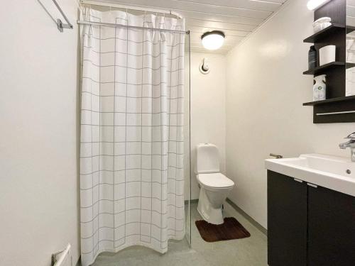 a bathroom with a shower curtain and a toilet at 8 person holiday home in Beddingestrand-By Traum in Beddinge Strand