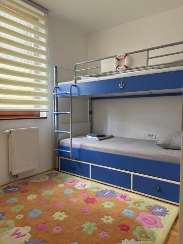 a bedroom with two bunk beds and a rug at Apartment Centar Sarajevo in Sarajevo
