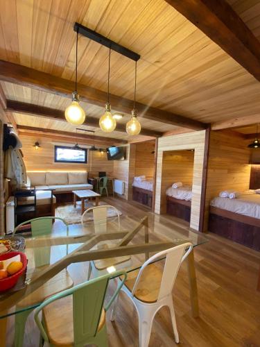 a room with a table and chairs and a bedroom at Tiny Under Chalet in Santiago
