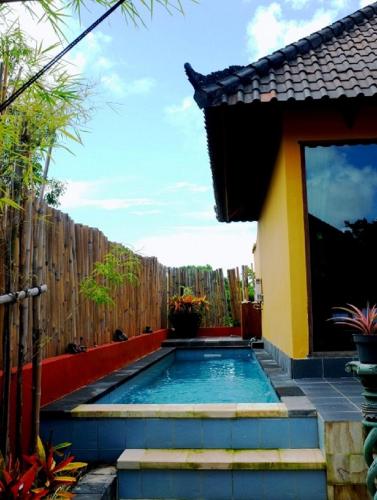 a swimming pool in the backyard of a house at Villa Anjing in Nusa Dua