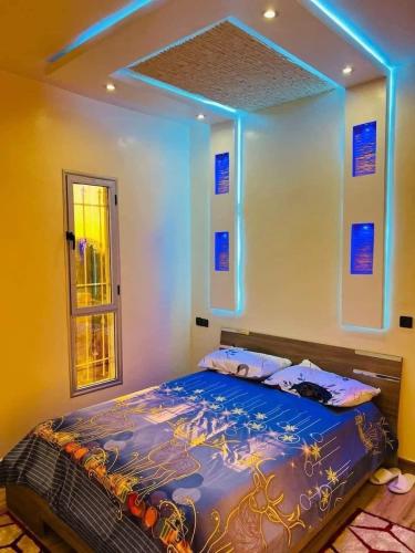 a bedroom with a bed with blue lights on it at Villa Nono & Zac Marrakech in Ourika