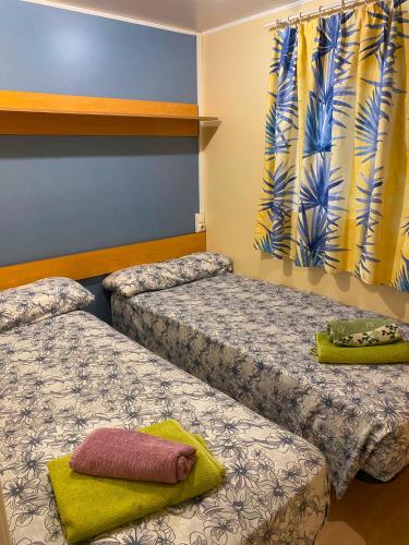 a room with two beds and a window at Little house paradise in Sant Pau dʼOrdal