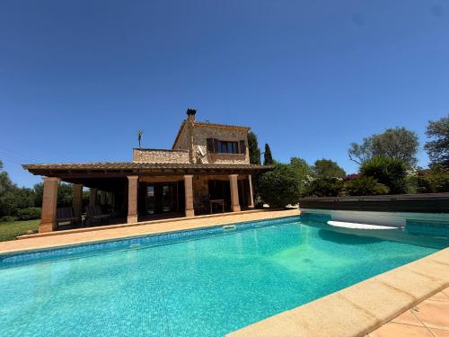 a villa with a swimming pool in front of a house at Finca Sara Christiana in Campos