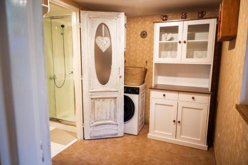 a bathroom with a shower and a white door at Valašská chalupa Červenka in Lužná