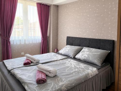 a bedroom with a bed with two towels on it at Central Apartments Kukoski Near Lake & Old Town in Ohrid
