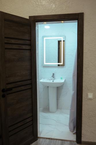 a bathroom with a sink and a mirror at Abelyans Fam Hotel in Alaverdi
