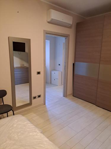 a bedroom with a bed and a large mirror at Le due Rive in Tufo