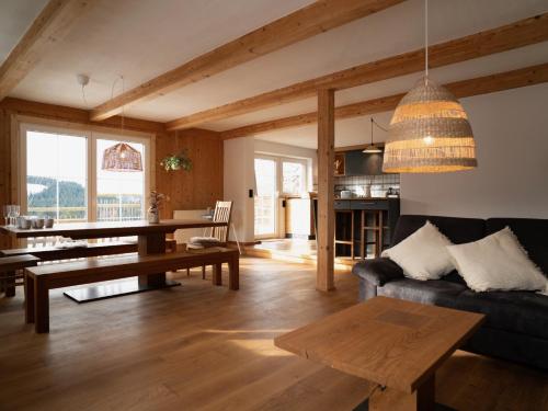 a living room with a couch and a table at Alpe Sonnenruh in Buchenberg