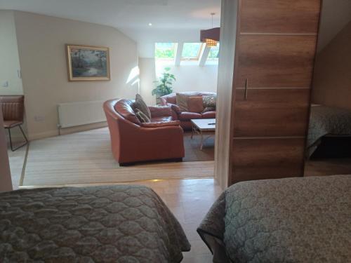 a living room with a couch and a chair at Ethan House Holiday Suites in Killarney