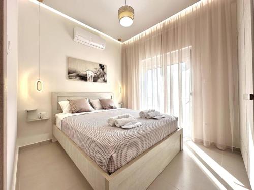 a bedroom with a bed with towels on it at Seaside Deluxe Apartment in Ialysos