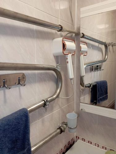 a bathroom with two towel racks and a mirror at A comfortable room with balcony in Tallinn