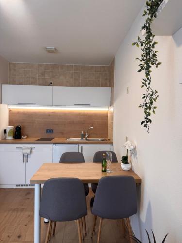 a kitchen with a wooden table and chairs at Adriany apartmán in Bayerisch Eisenstein