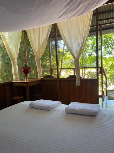 a bedroom with two white pillows on a bed at Majacho`s House in Puerto Maldonado