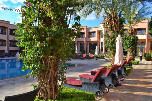 a resort with a pool and chairs and a umbrella at Zalagh Kasbah Hotel & Spa in Marrakech