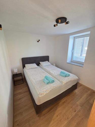 a bedroom with a bed with two towels on it at The Kiwi House in Ohrid