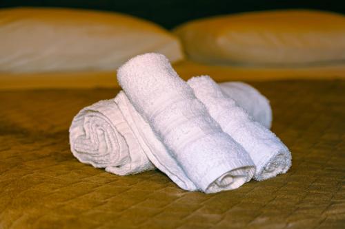 a white towel sitting on top of a bed at La Dimora di Alba in Palermo