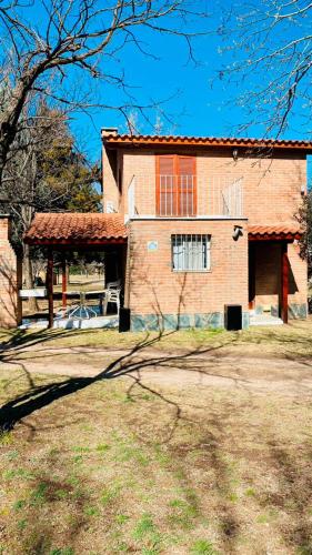 a large brick house with a roof at Aromas del Mediterraneo Casa de Montaña 2 in Arroyo de Los Patos