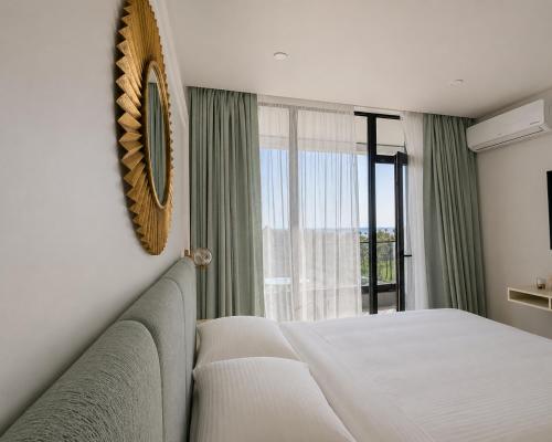 a bedroom with a bed and a large window at Mar y Sol in Batumi