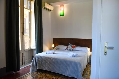 a bedroom with a bed with towels on it at La Dimora di Alba in Palermo
