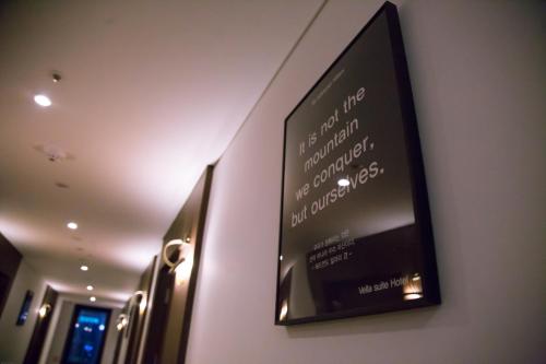 a sign on the wall of a hotel room at Vella Suite Hotel in Suwon