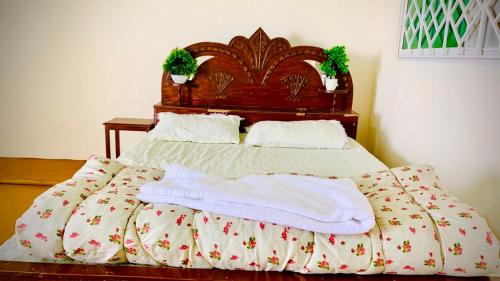a bed with two white towels on top of it at Murree Sky Heights in Khaira Gali