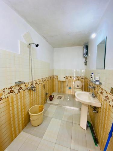 a bathroom with a sink and a toilet at Murree Sky Heights in Khaira Gali