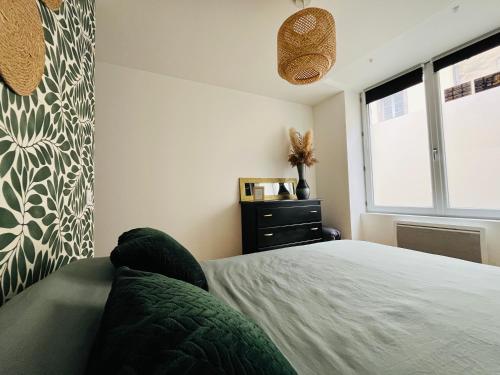a bedroom with a bed and a window at Mon petit cocon auvergnat in Combronde