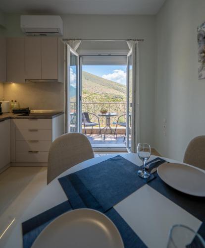 a kitchen and dining room with a table and a window at Gerania nature Residence 21 in Siátista