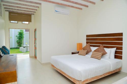 a bedroom with a large bed and a large window at Cloud 9 Boutique Hotel in Negombo